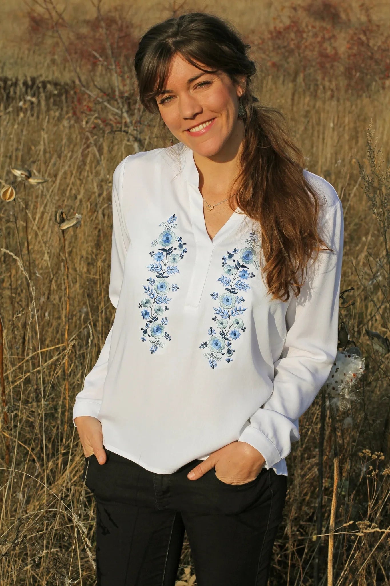 Blouse blanche ample et fluide pour femme. Agrémentée d'une magnifique broderie Palóc dans des tons bleus très délicats.