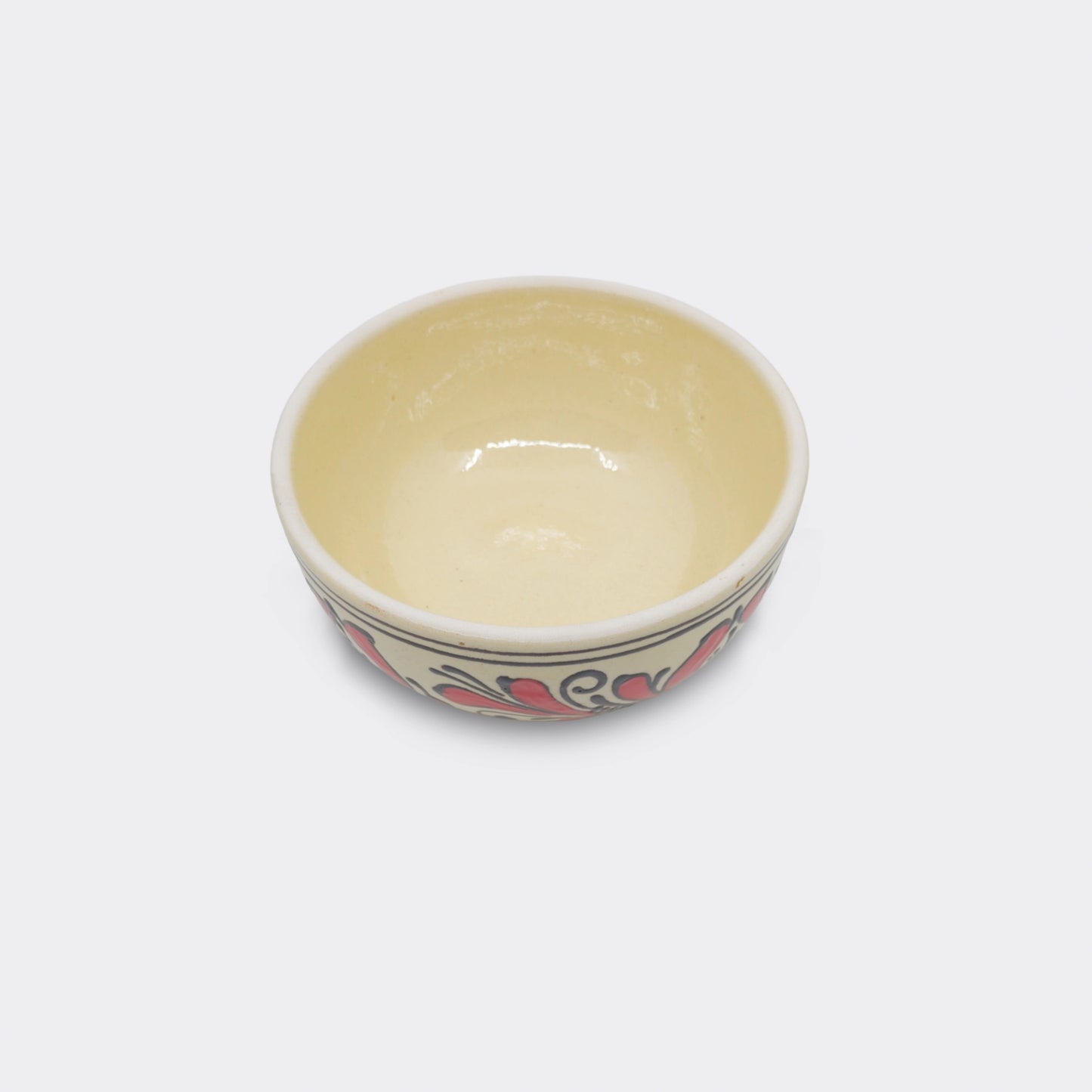 Bol en céramique de Transylvanie, vue intérieure émaillée. Fond crème et finition artisanale.