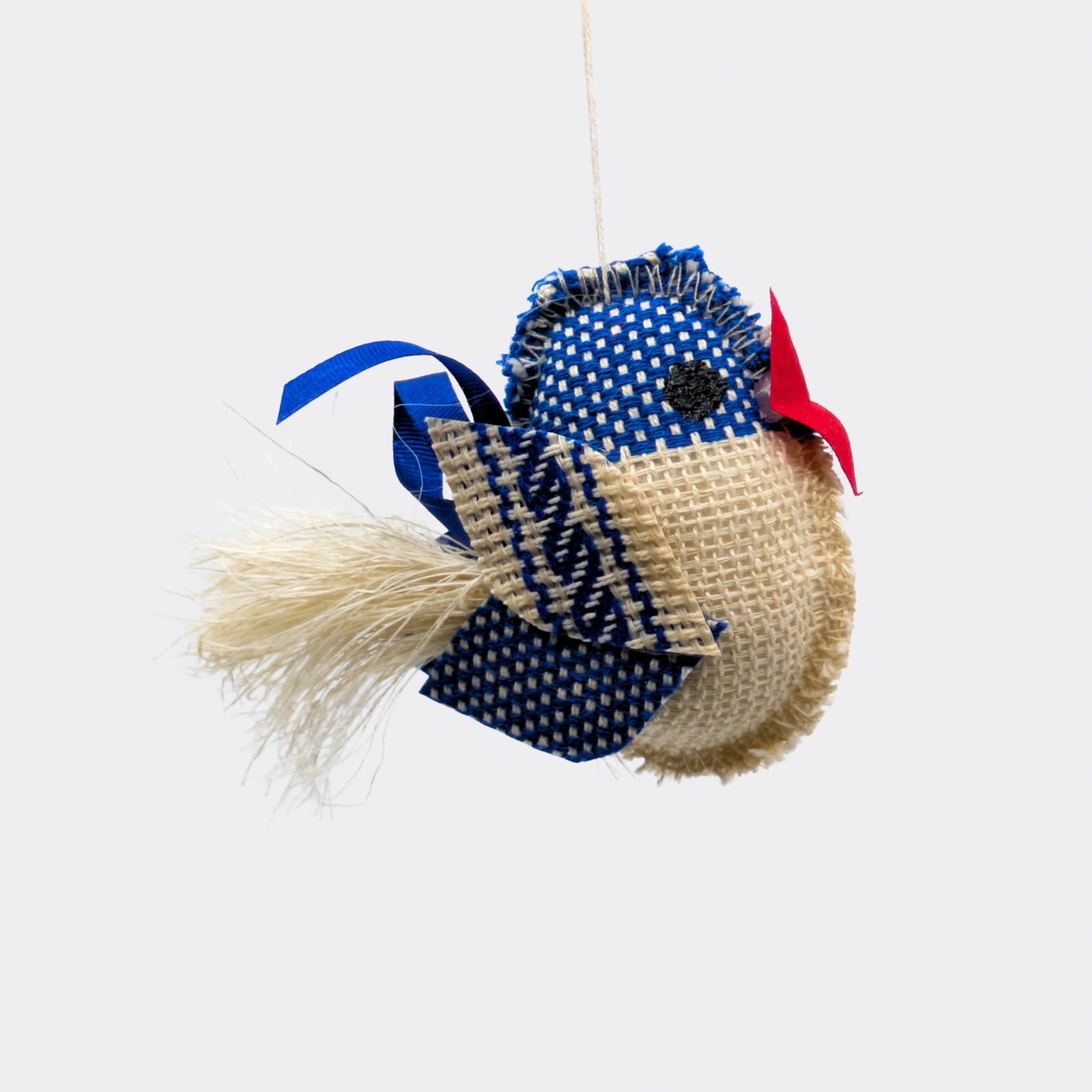 Oiseau bleu à pois blancs et ecru à suspendre pour Noël ou autres occasions festives. Fait main en République Tchèque.