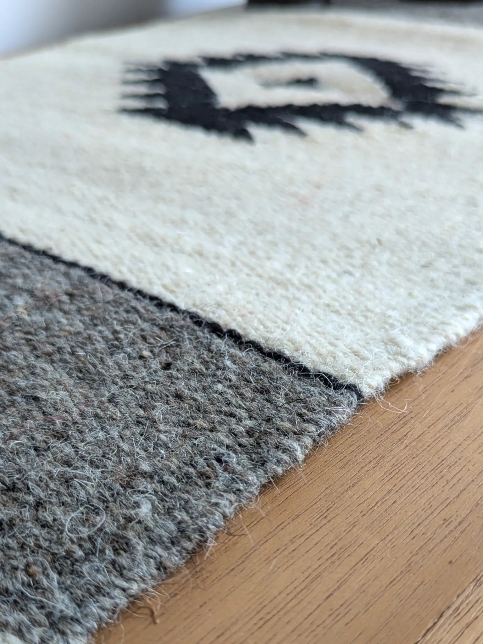 Petit kilim crème et gris en laine, détail du tissage et du motif noir