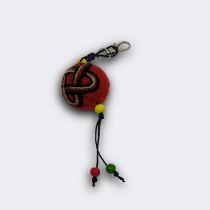 Charm artisanal Solomun doté d'une boule en feutre rouge avec le motif du nœud de Salomon